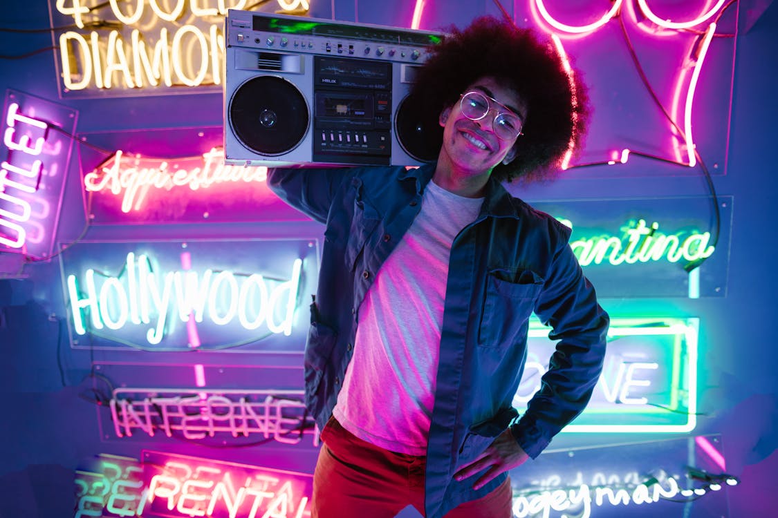 Man in Black Leather Jacket Standing Near Radio