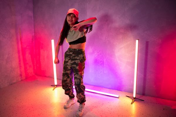 Portrait of hip-hop choreographer Lena Ortiz in pink neon light
