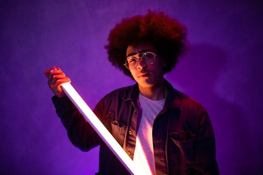 Portrait of a stylish young adult holding a neon light with vibrant, artistic vibes.