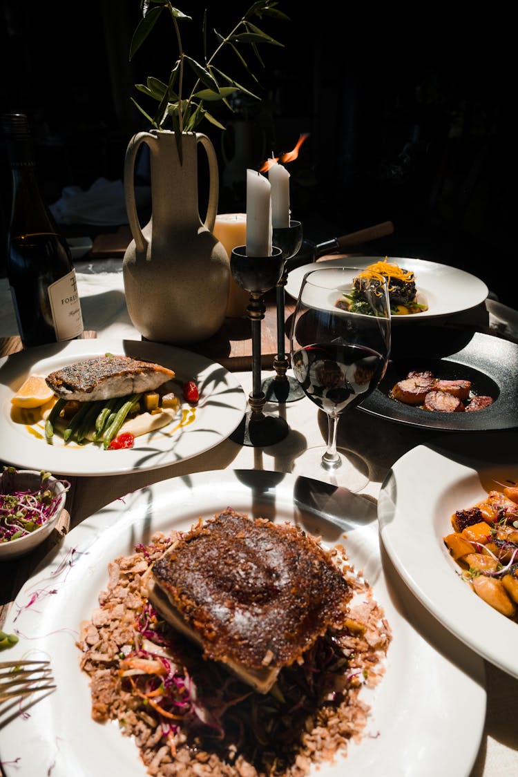 Various Gourmet Dishes On A Dining Table