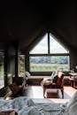 Brown Wooden Framed White Padded Armchair Near Window