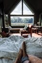 Brown Wooden Armchair Beside White Bed