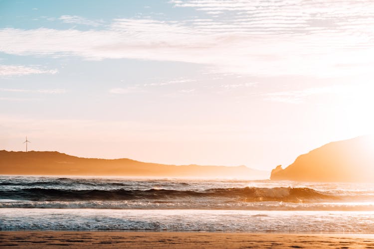 Beautiful Seascape With Silhouetted Hills At Sunrise