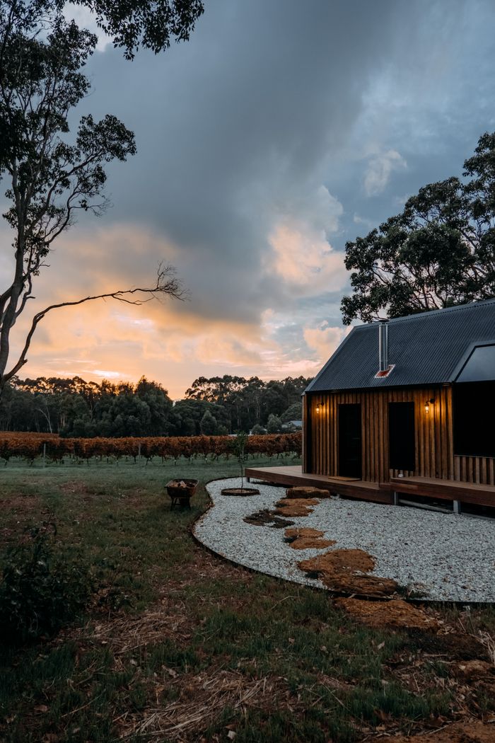 Timber cabin beside a vineyard at dusk — photo by Rachel Claire on Pexels