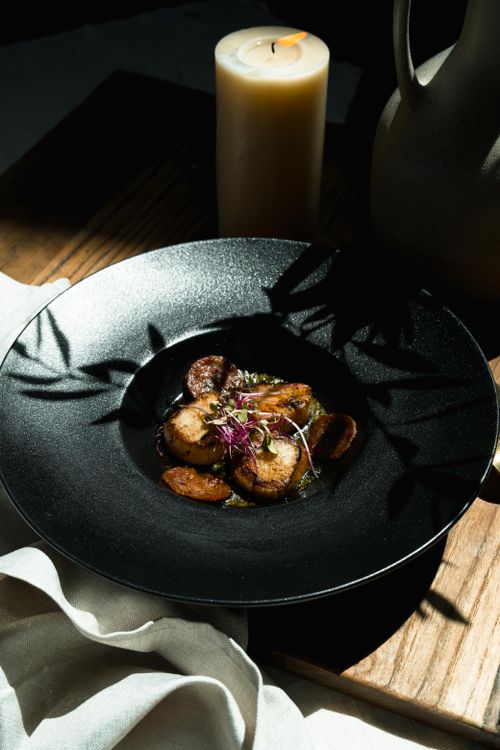Free Savor the elegance of this gourmet meal elegantly lit by candlelight, perfect for fine dining. Stock Photo