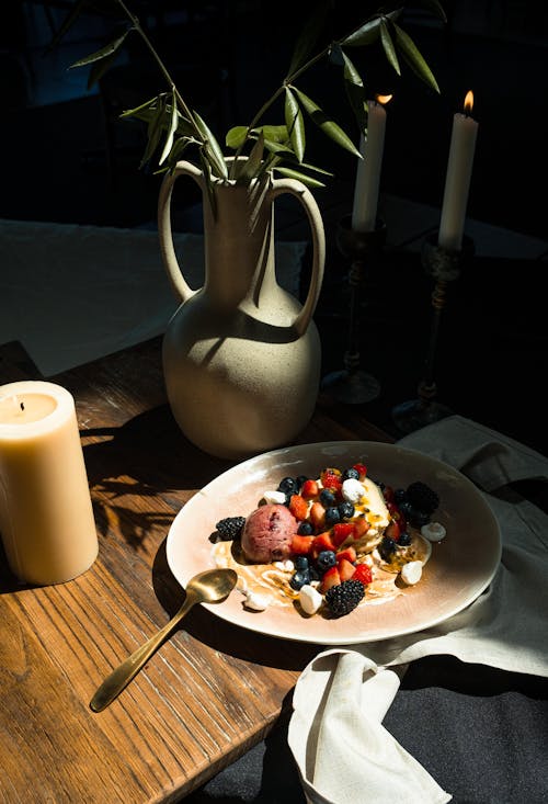 Plate with Fruit and Ice Cream on a Table 