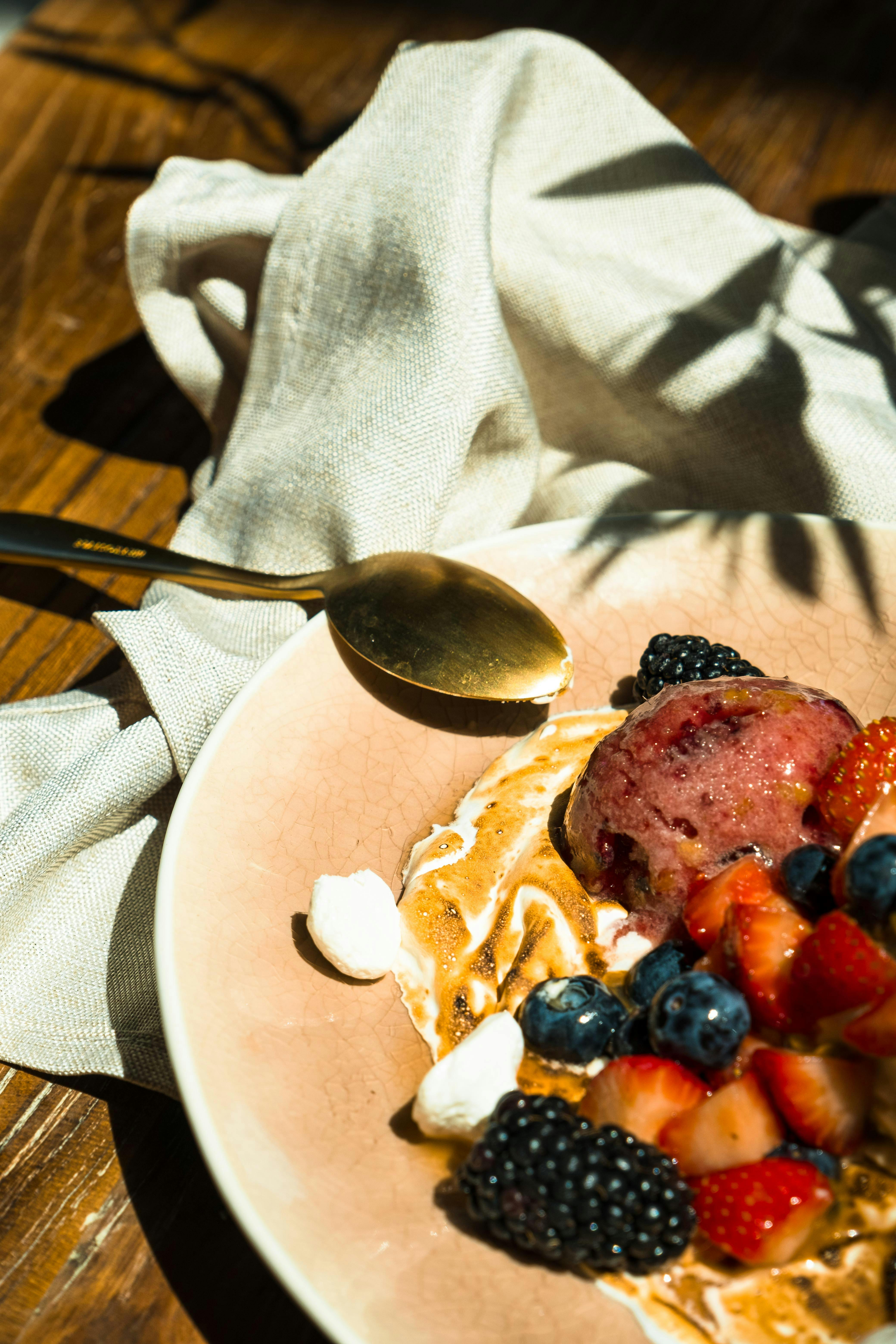 close up of a dessert with fruit and ice cream