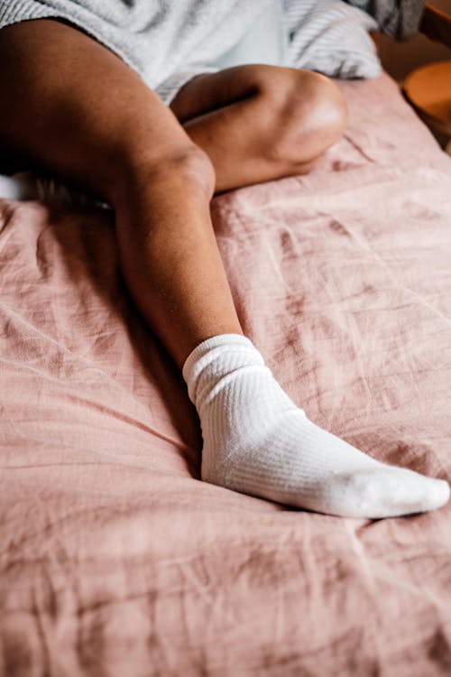 Photo of a Person's Foot Wearing a White Sock