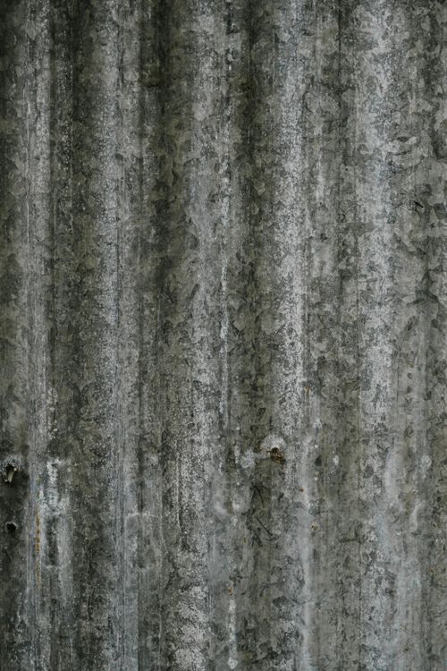 Free Close-up view of a textured corrugated metal surface with a rustic appearance. Stock Photo