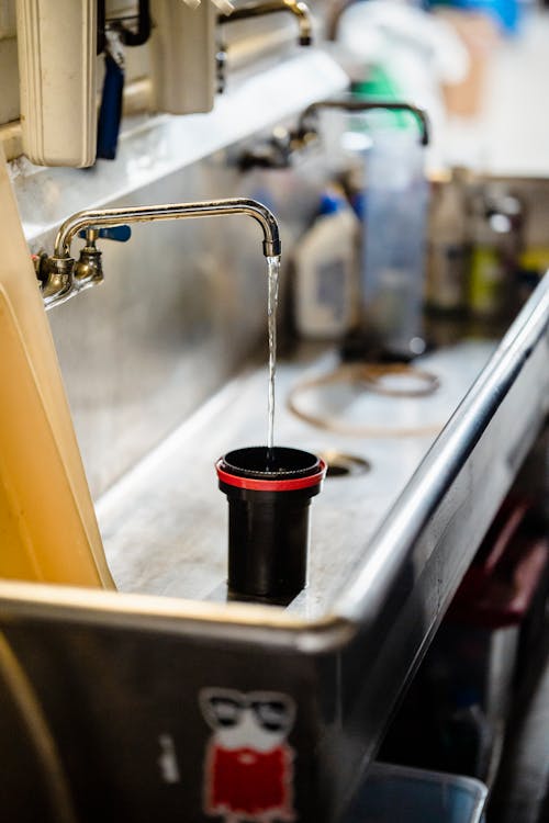 Free Black and Red Cup on the Sink Stock Photo