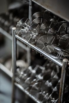 Artistic perspective of metallic spirals in a stainless steel rack, showcasing industrial design.
