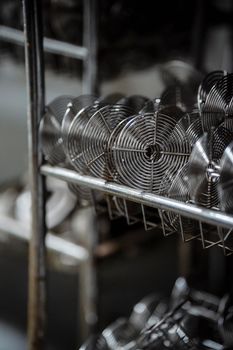 Detailed view of stainless steel wire mesh racks in an industrial setting.