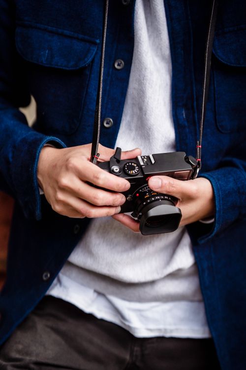 Free Close-up of a person holding a vintage camera, capturing a candid moment. Stock Photo