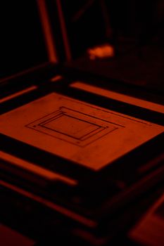 Abstract design of a frame in a dark room, highlighting geometric shapes.