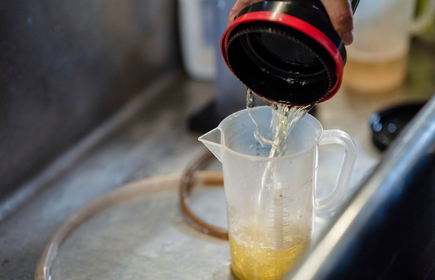 Detailed view of water being poured into a measuring cup, perfect for illustrating precision in liquid measurement.