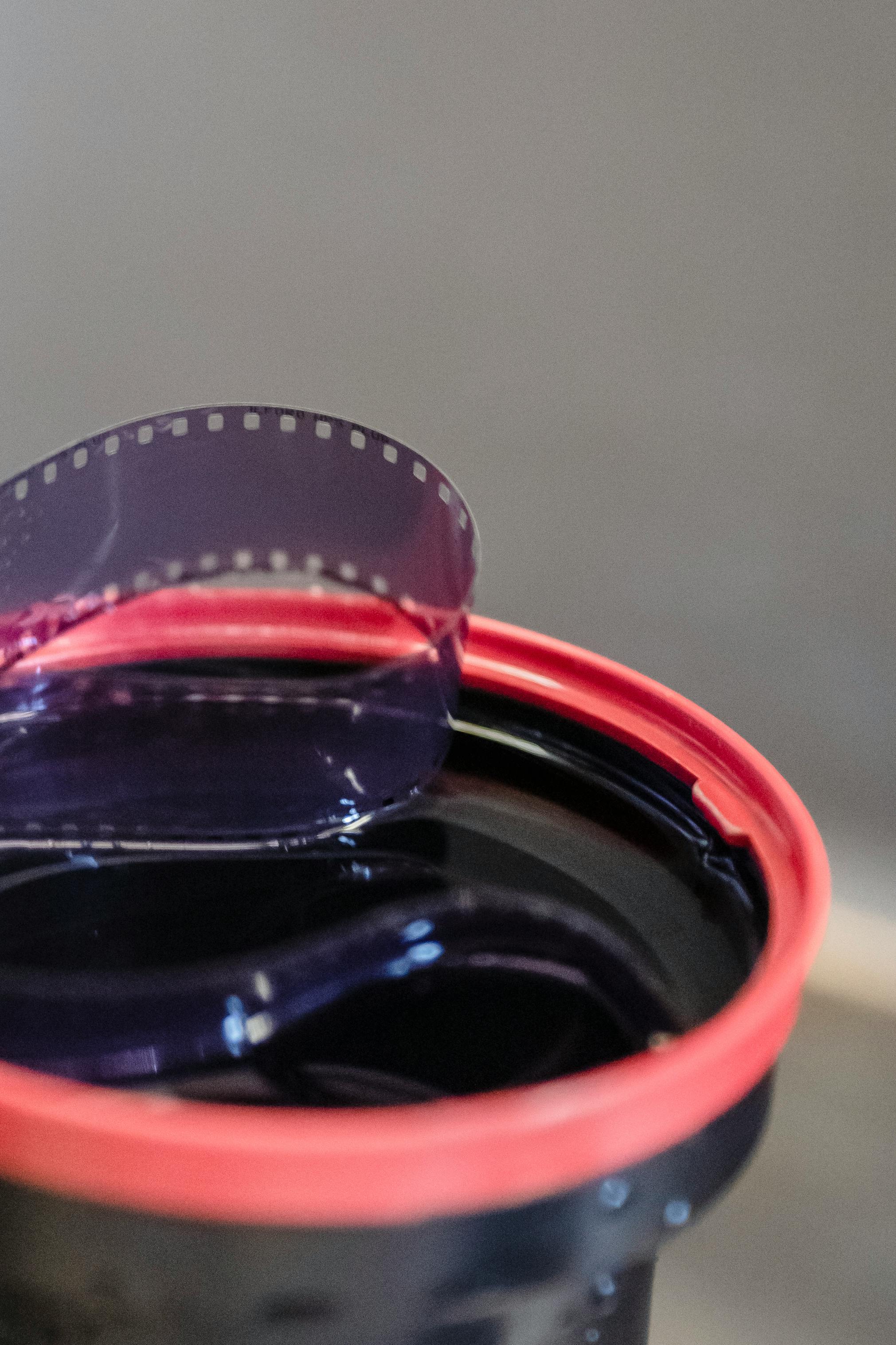 A detailed view of a film reel inside a developing tank, perfect for photography and film editing themes.