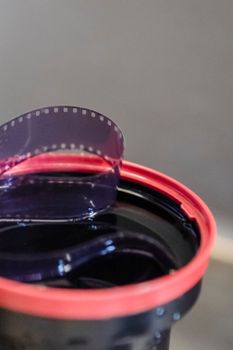 A detailed view of a film reel inside a developing tank, perfect for photography and film editing themes.