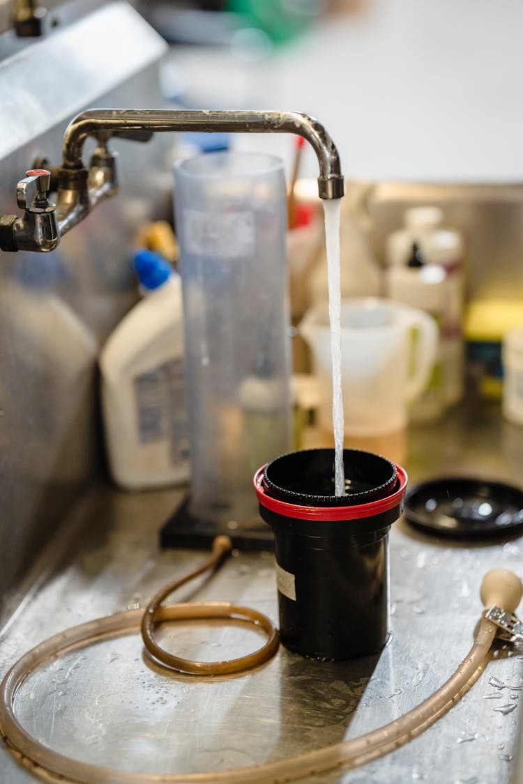 Pouring Water To Cup From Sink