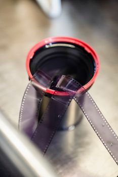 Close-up of photographic film in a developing tank, showing analog photography practice.