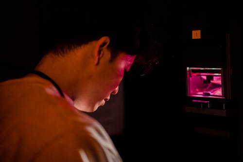 Man Working with Equipment for Developing Photographs