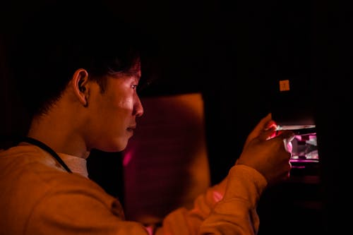 Close-up of Man Developing Pictures in a Darkroom