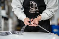 Person in White Jacket Holding Silver Scissors