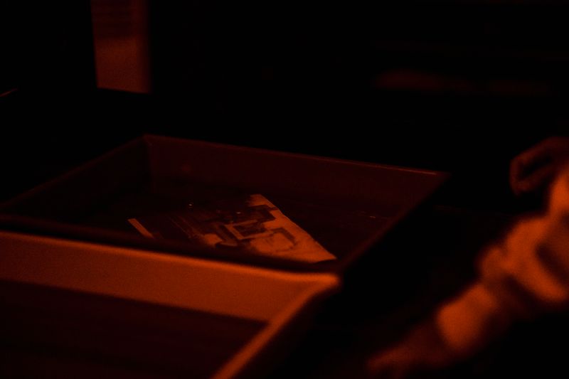 a developing tray glowing in a darkroom — photograph by Annushka Ahuja on Pexels