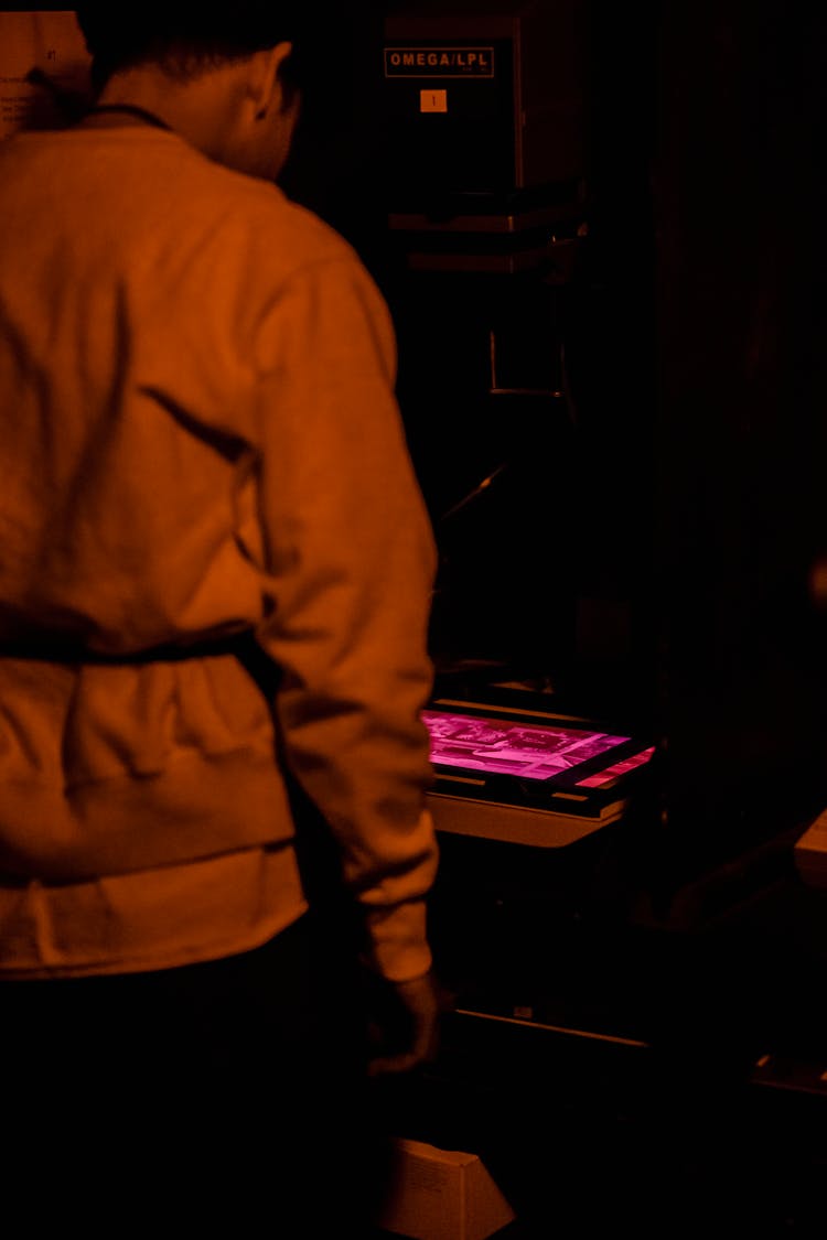 Man Developing Photo In Studio In Dark