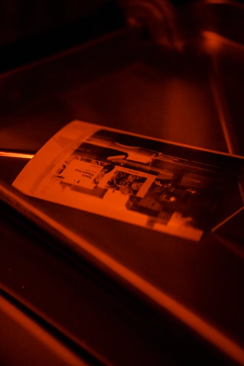Close-up of Pictures Developing in a Darkroom