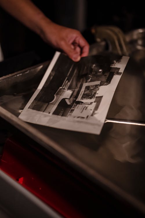 Close-up of Man Developing Pictures in a Darkroom