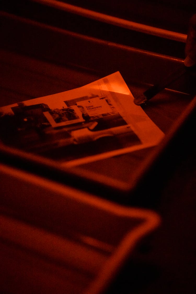 Close-up Of Pictures Developing In A Darkroom 