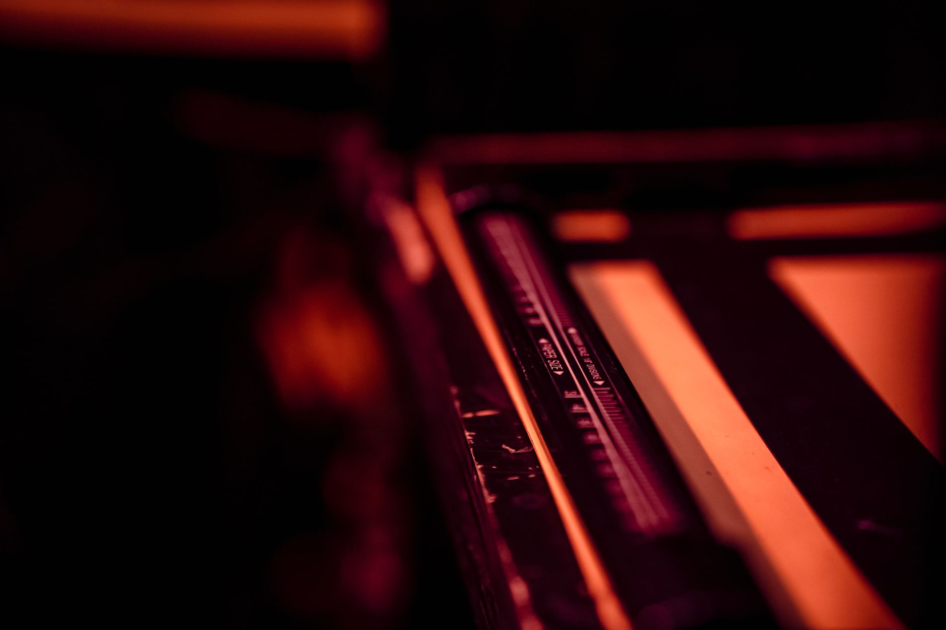 Close-up of darkroom photography equipment in a warm, defocused ambiance.