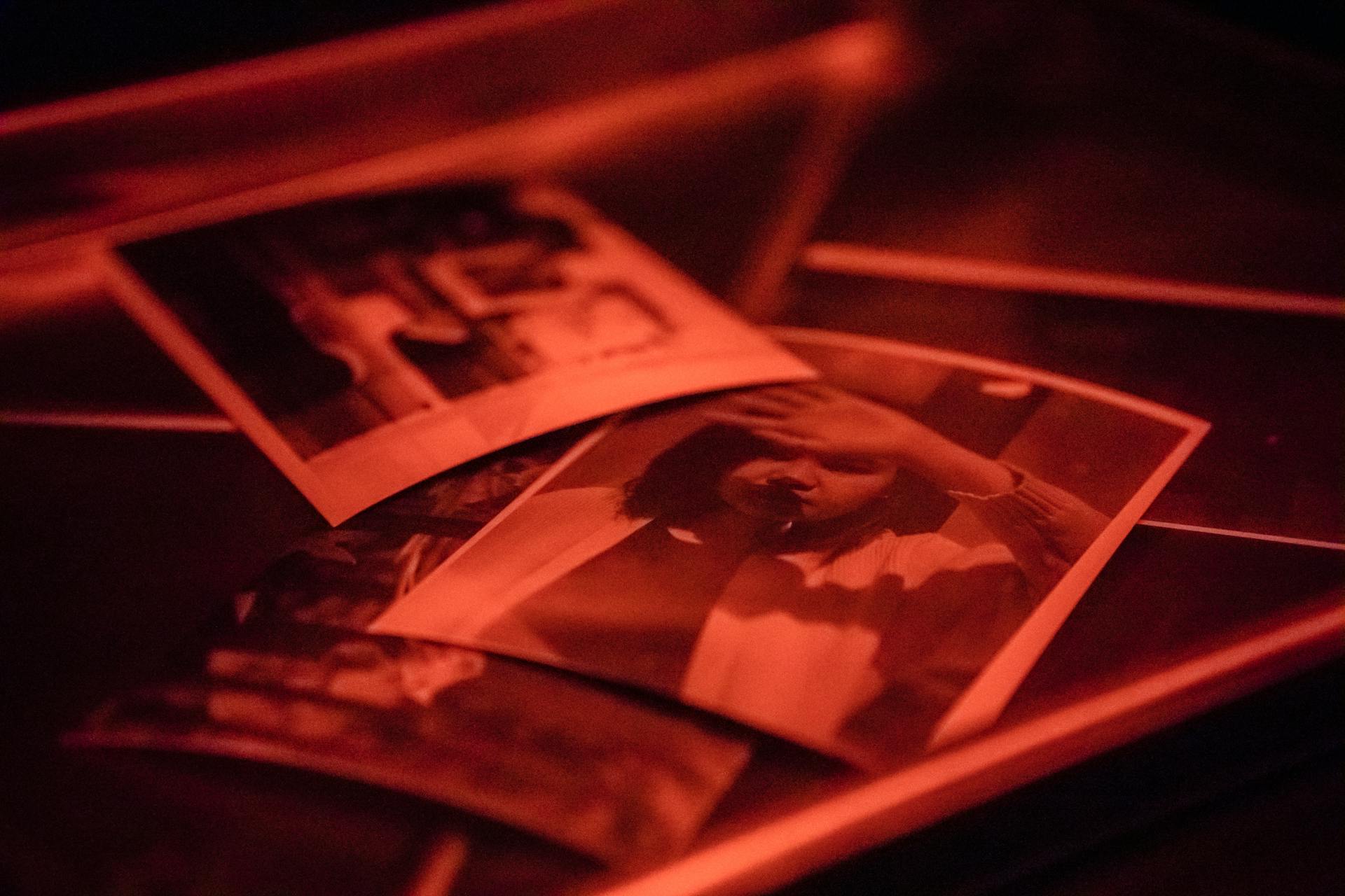 Photographs in Red Lit Darkroom