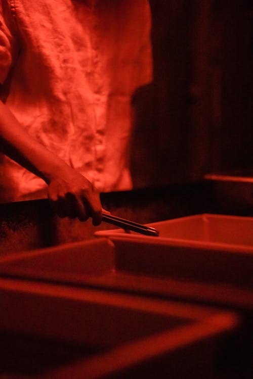 Man working in Red Lit Darkroom