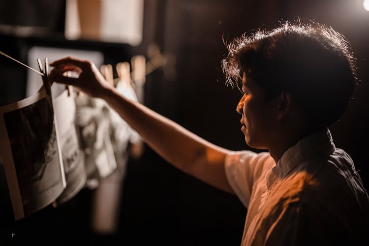 A Man Hanging Photographs