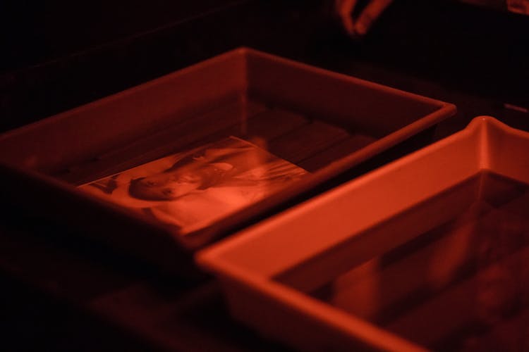 Developed Photographs Lying In Box In Dark Room