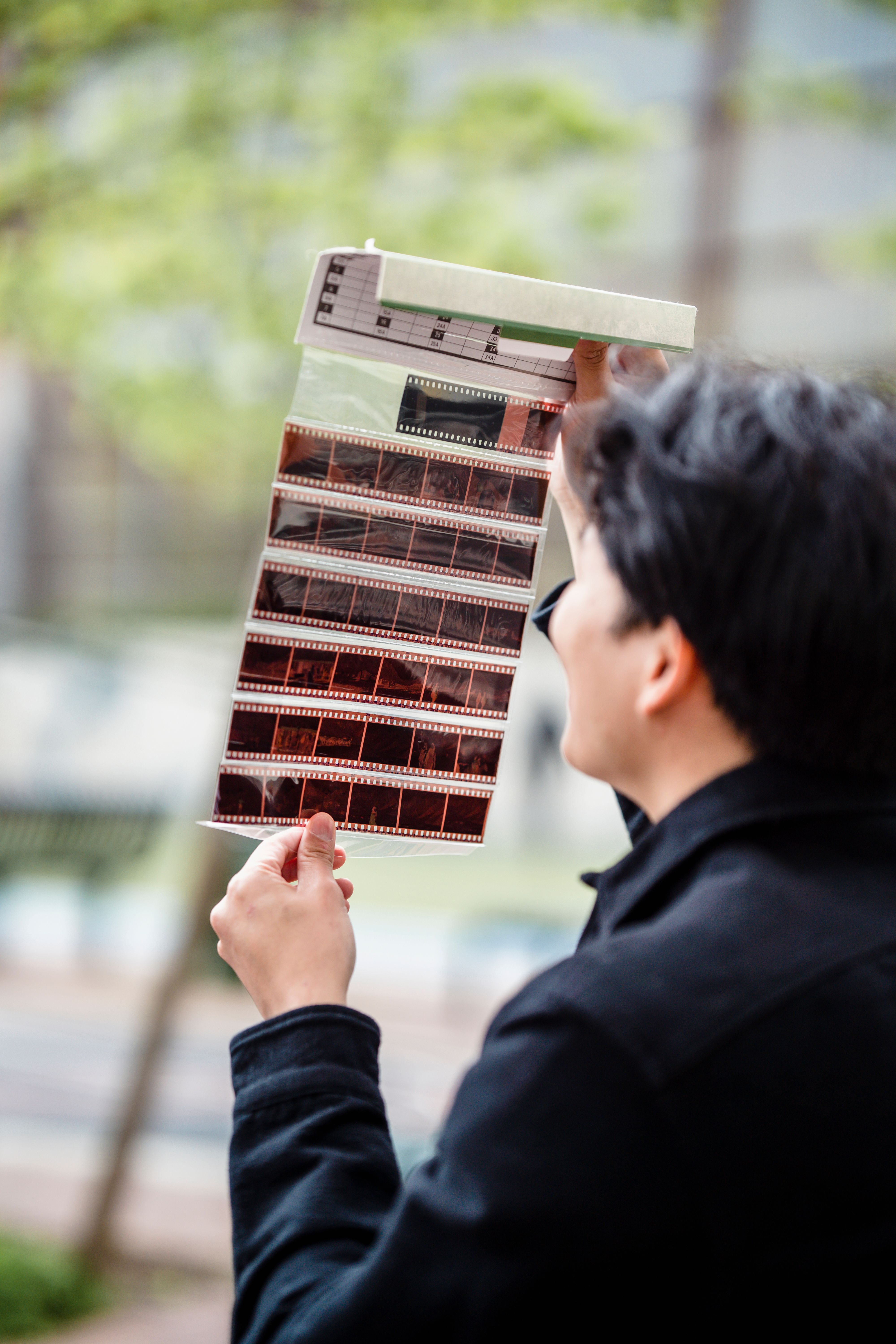 Man Looking at Undeveloped Film · Free Stock Photo