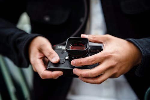 A Person Holding a Black Camera 