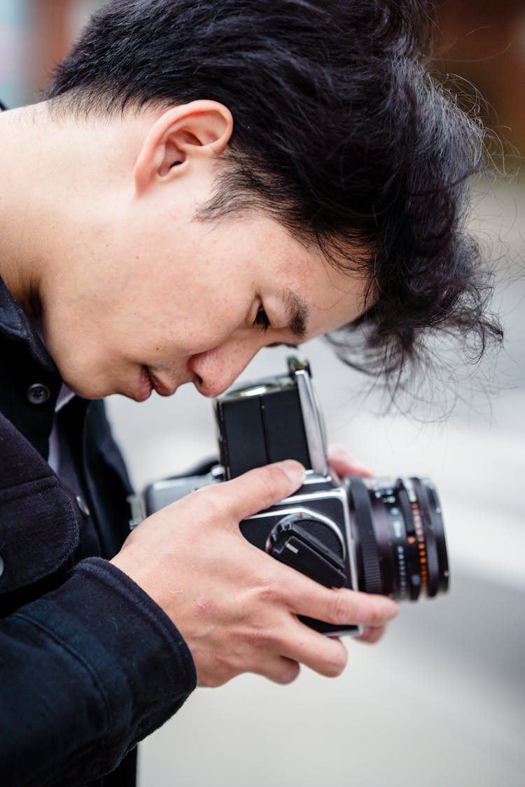 Portrait Of A Man Taking A Picture With A Vintage Camera 