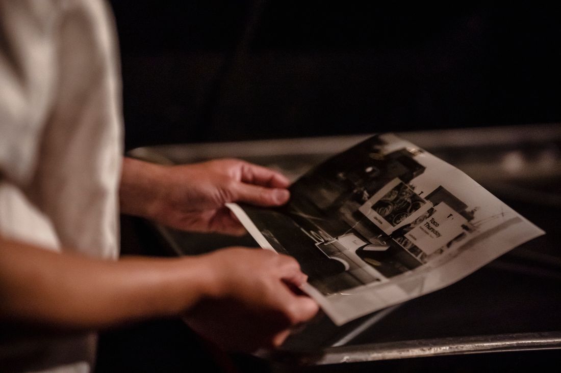 Print craftsman inspecting a freshly developed photograph