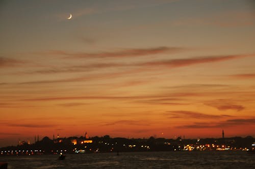 Free stock photo of crescent moon, night lights, sunset