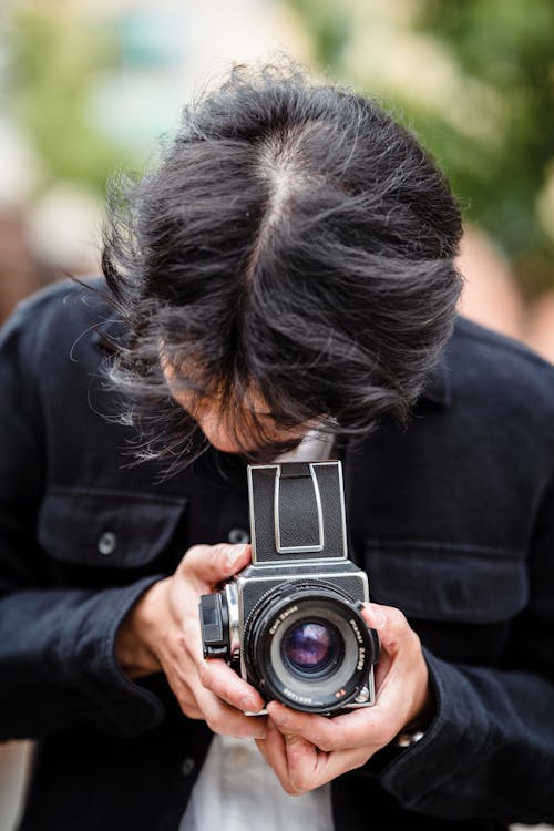 Man Photographing with Analogue Camera