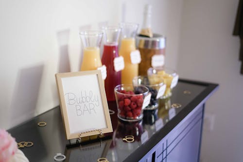 Free Bubbly Bar Sign With Several Assorted-color Liquid With Bottles on Top of Black Wooden Table Stock Photo