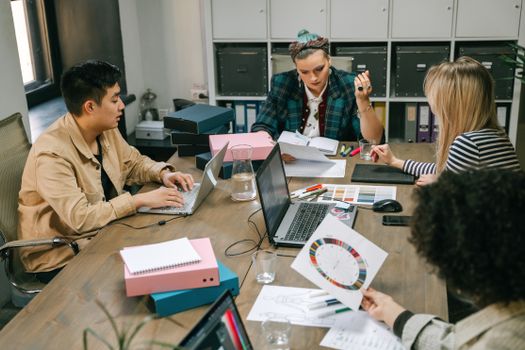 A group of professionals engaged in a planning meeting at the office, showcasing teamwork and collaboration.