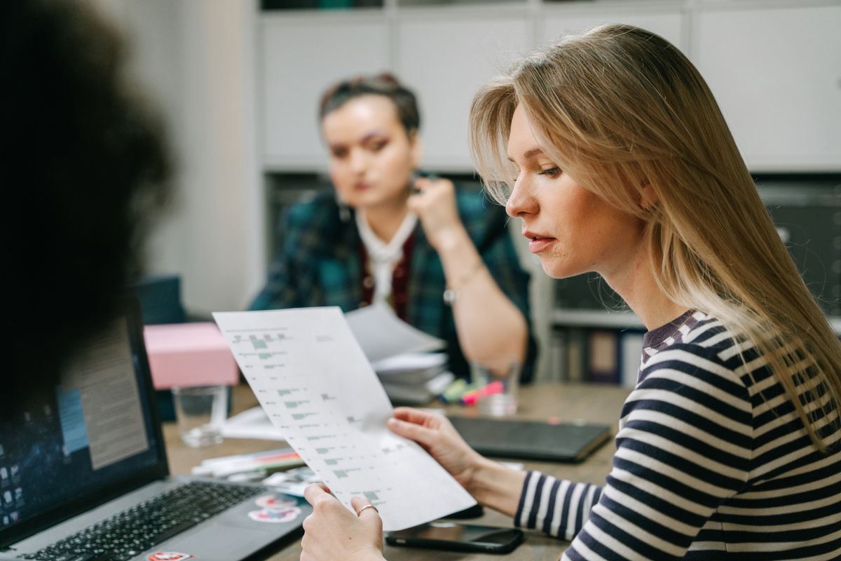 Woman reviewing paperwork during a business meeting