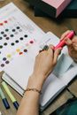 Person Holding Pink Pen and White Printer Paper