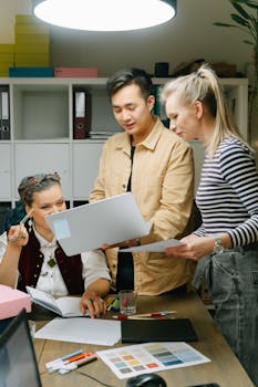 Diverse coworkers engaged in a creative meeting, planning project strategies in a modern workspace.