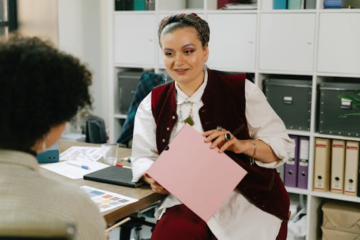 Professional women discussing a project in an office setting.