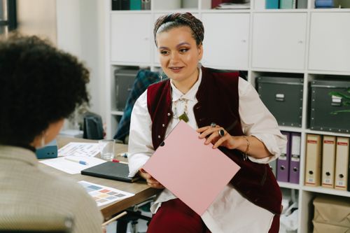 Free Professional women discussing a project in an office setting. Stock Photo