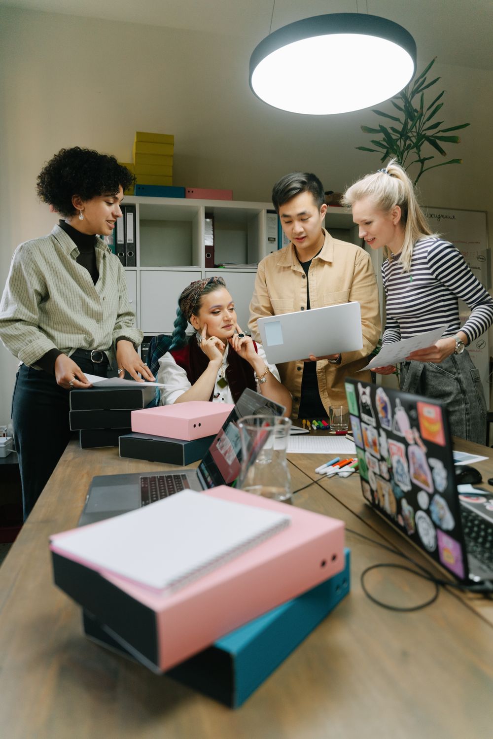 A diverse team of professionals collaborating around a table in a modern workspace
